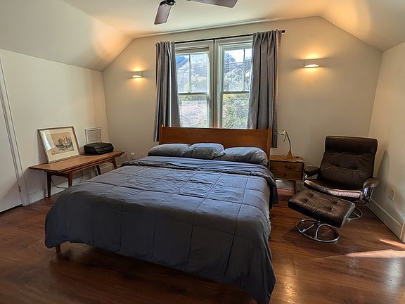 Large bedroom with desk and queen size bed