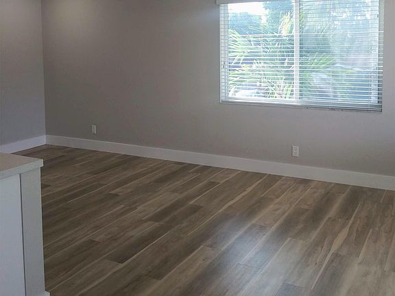 spacious sun-filled great room with new luxury vinyl planking floors
