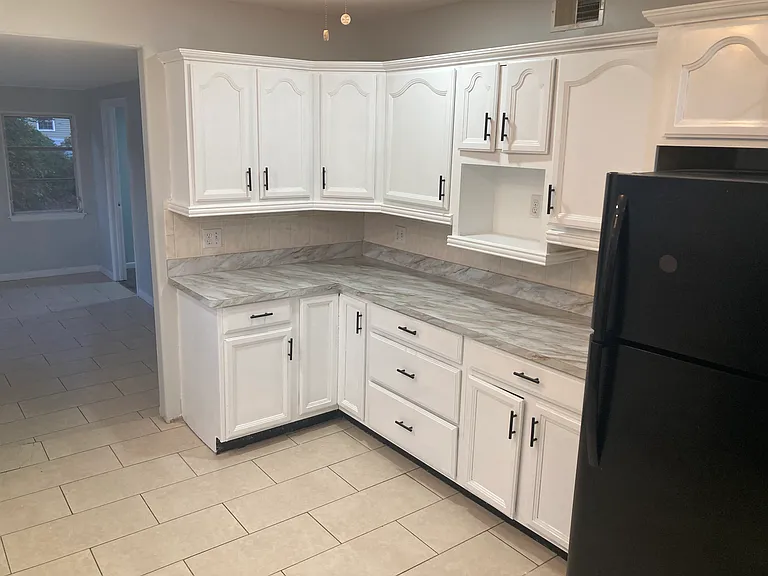 Kitchen other side- tons of cabinets overall