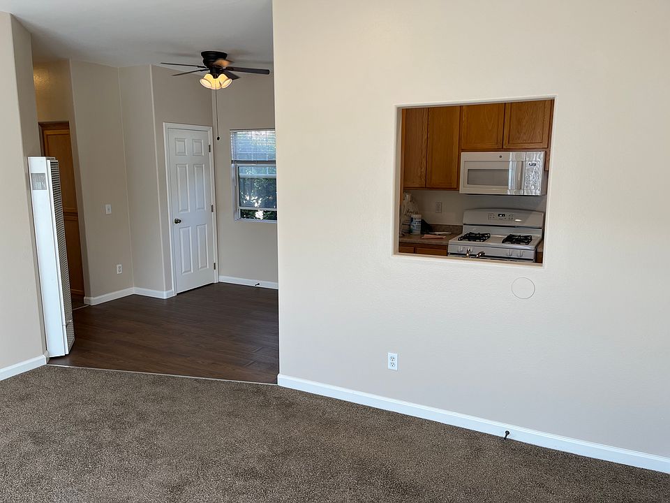Kitchen looks into large living room with fireplace