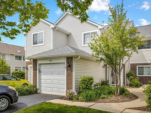 Attached garage with additional parking on the driveway