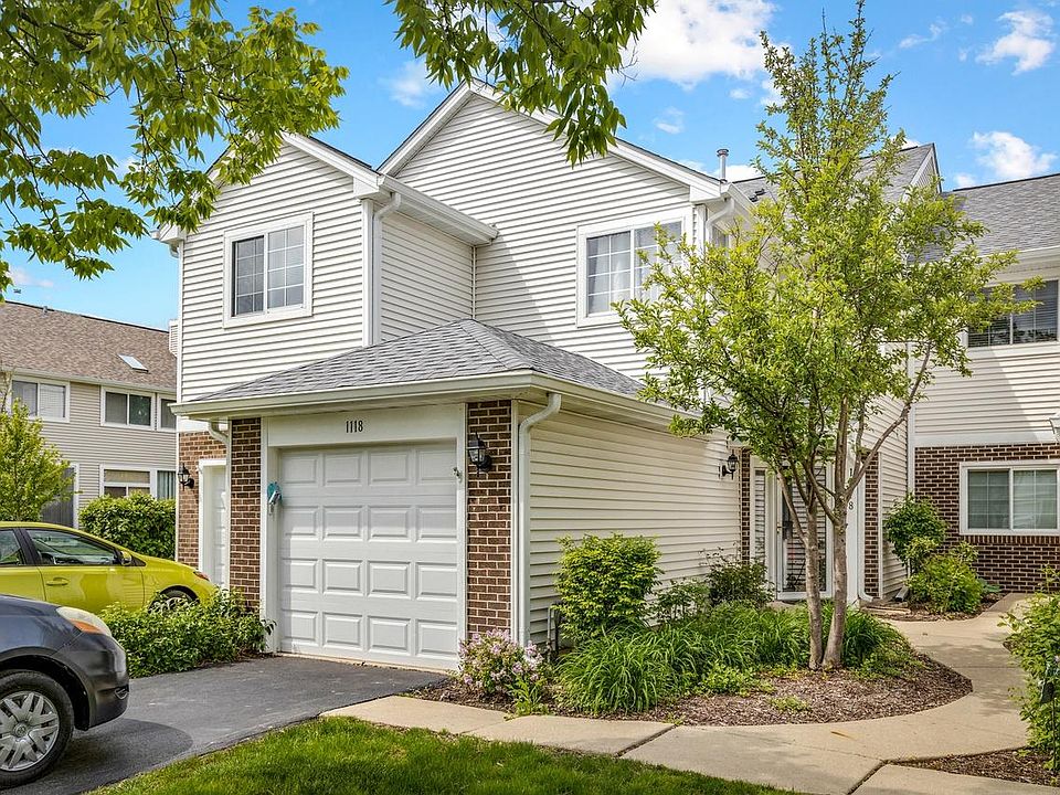 Attached garage with additional parking on the driveway