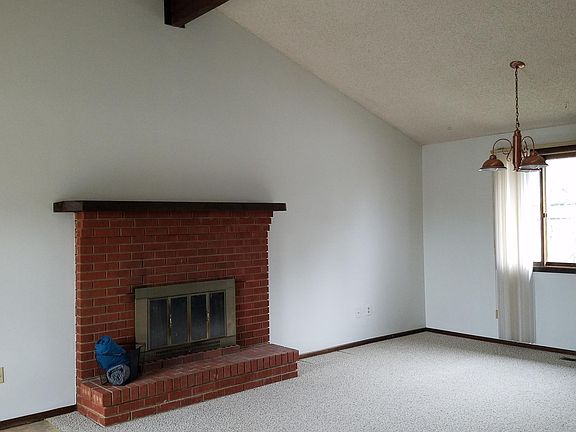 vaulted ceiling living room with fireplace