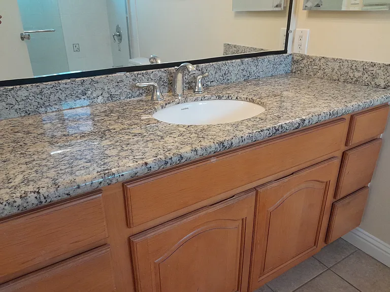 Master Bathroom with marble countertop, shower-tub combo, and tile floor