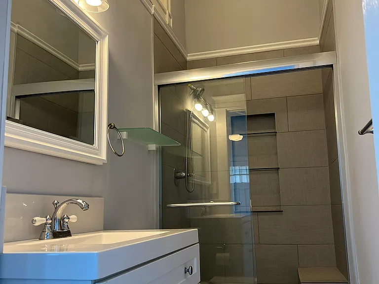 Bathroom with single vanity and large glassed shower