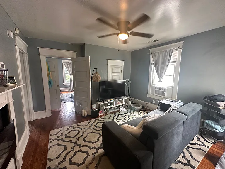 Previous Photo prior to new paint - Living Room w/ Original Hardwood Floors and Designer Lighting. All Blinds provided by landlord.
*Apartment has been painted w/ Sherwin Williams French Gray!*
