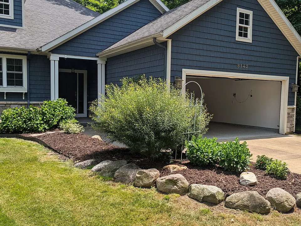 Entry , two car garage and beautiful landscaping.