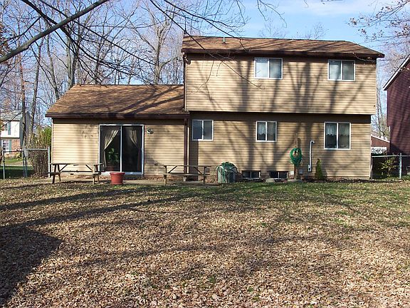 fenced in back yard with shed that has electricity