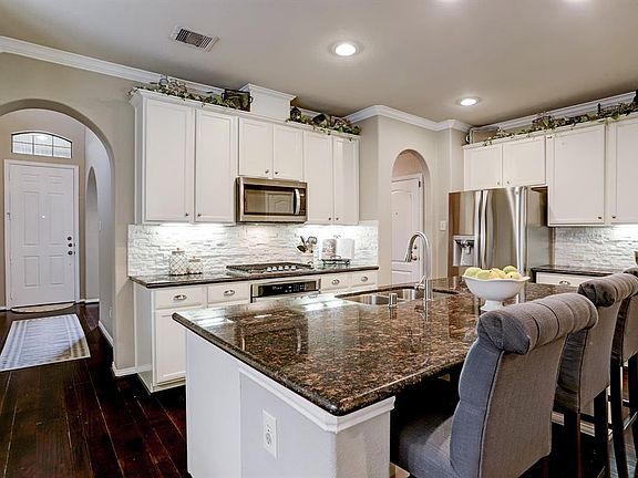 This home has it all! Updates galore throughout, especially in the kitchen, with granite counters, white cabinetry, neutral walls, a stacked stone backsplash, and stainless steel appliances that were recently installed.