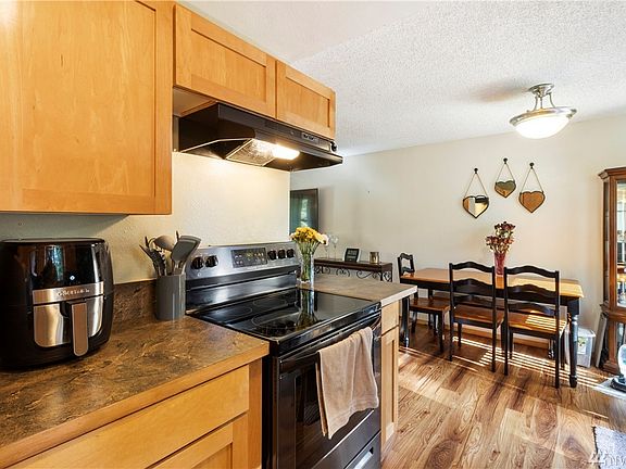 New Maple Cabinets, stove,sink and new floor in the kitchen and nook area. 