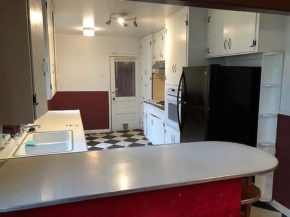 Kitchen with built in oven and range, new flooring.