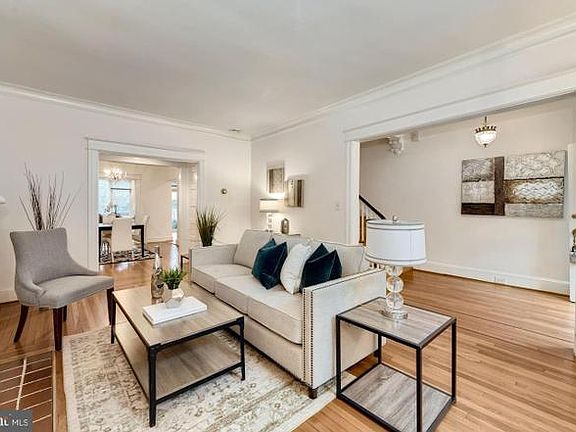 Living room with view into front entrance on right and dining room on left.