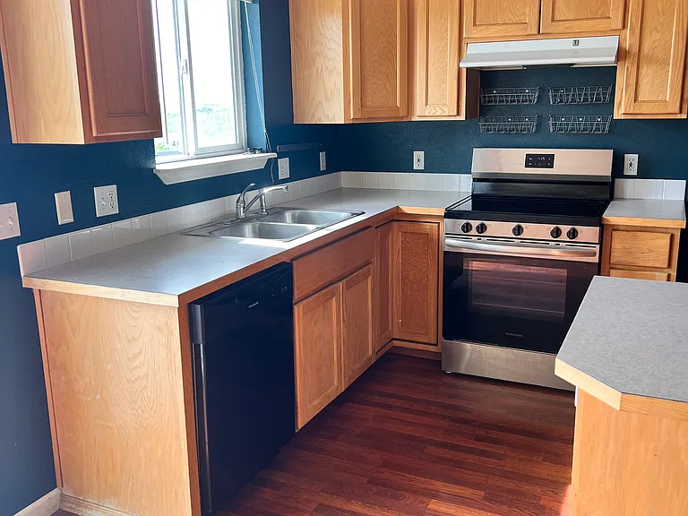 Kitchen with new stove and dishwasher