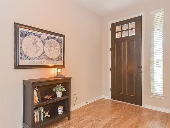 Welcoming entry door with glass details and sidelight.