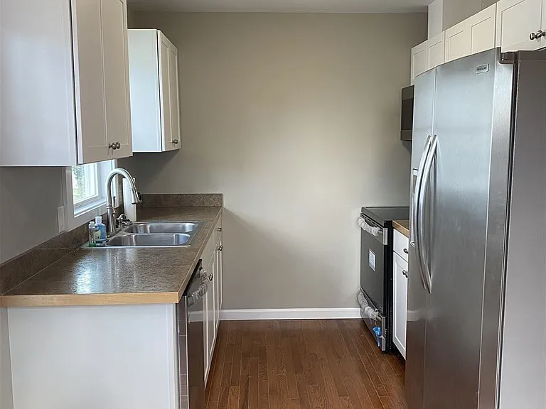 Kitchen includes fridge/freezer, microwave, electric range oven, dishwasher, garbage disposal, dual sink