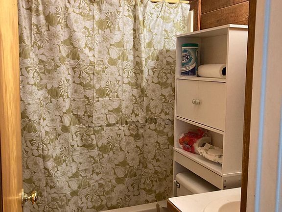 Full bathroom with shower, tub and vanity.