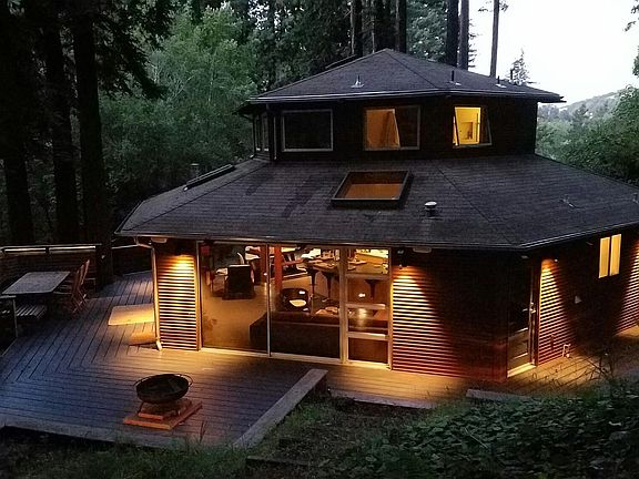 Exterior view of house and wrap-around deck.
