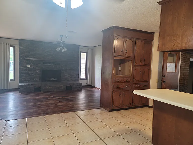 standing in SunRoom looking at Living room, Kitchen on Right.