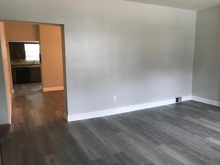 Another view of living room, dining room, kitchen.