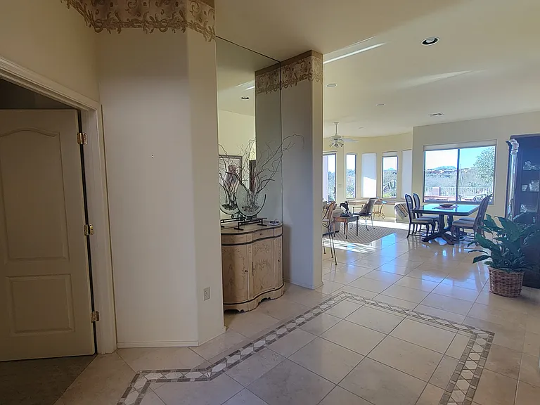 Spacious welcoming entryway. Den/Office is to the left. Guest room and 2nd bath to the right. Master separate off living room. Entire house has 10 ft. ceilings.