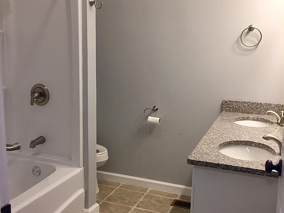 Master Bath with shower/tub combo and double sinks with granite vanity top.