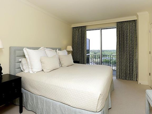 Master bedroom with floor to ceiling windows overlooking River Oaks and Memorial Park. Custom block-