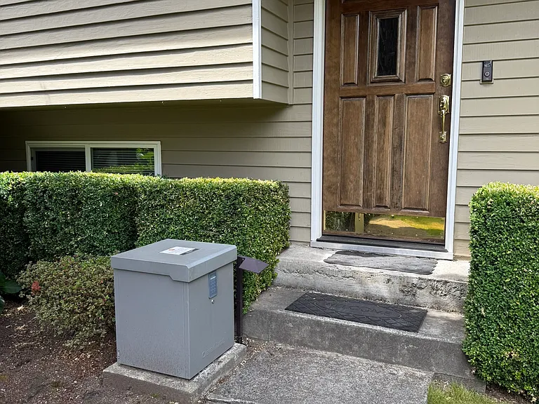 Photo of the front door. Notice the lock box to ensure your Amazon packages stay safe!