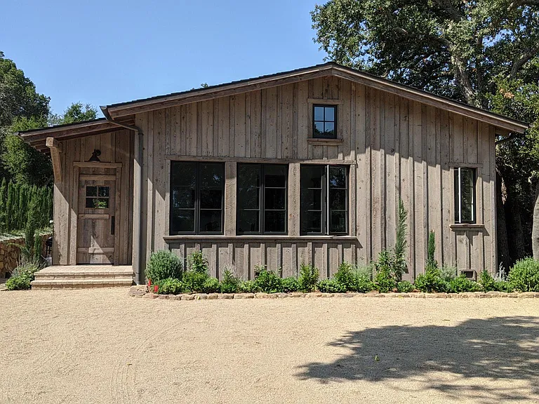 entry with barn door and reclaimed wood siding