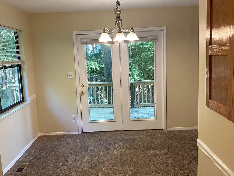 Kitchen looks out to dining room with French doors to deck.