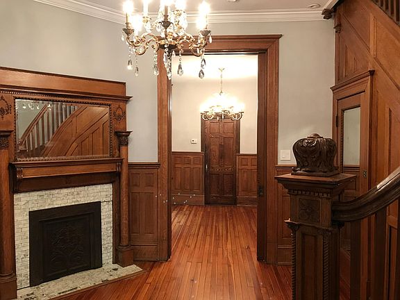living space with original mantle piece and decorative fireplace.