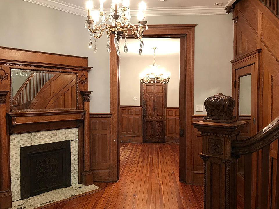 living space with original mantle piece and decorative fireplace.