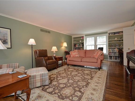 Spacious living room with built-ins and gleaming hardwood floors