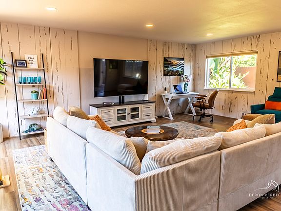 This home-away-from-home includes an expansive great room designed for both comfort and connection. With a spacious sectional and natural light, this coastal- inspired living space is perfect for relaxing, entertaining, or gathering with family & friends