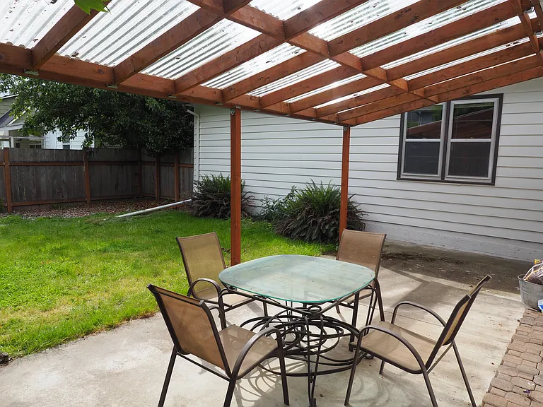 Covered patio in enclosed back yard looking towards the south.