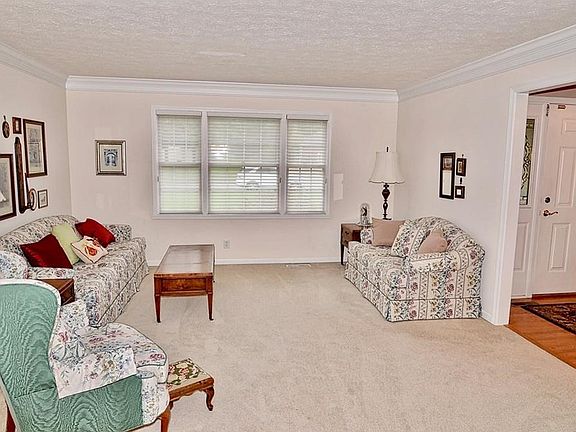Formal living room off the entry has crown molding.