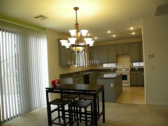 Kitchen opens to dining area and sliding glass door to huge balcony