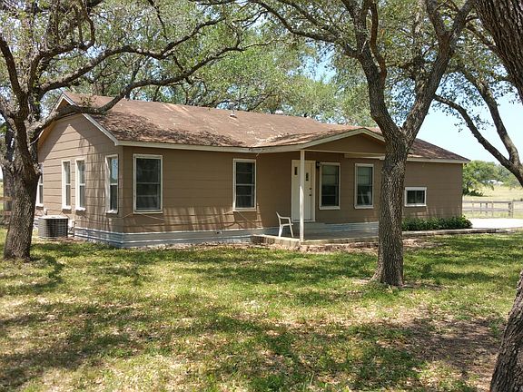 Front view of the home. There are multiple mature oaks and the home has central air and heat.