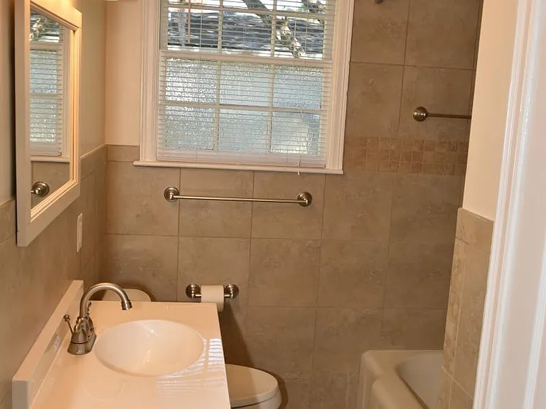 Bath: Linen closet, towel rods, porcelain tile, decorator lighting, exhaust fan, 3 compartment vanity