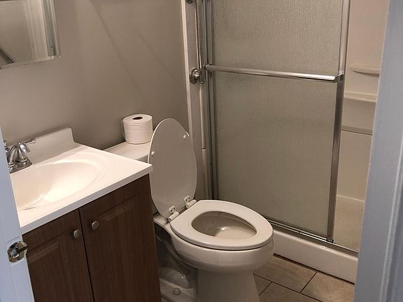 Full Bathroom with hinged mirror medicine cabinet