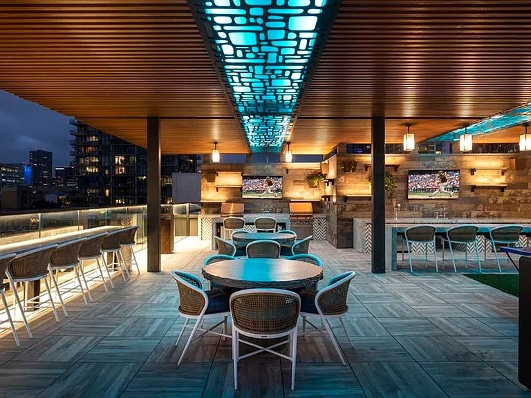 The rooftop entertainment area is perfect for watching the big game on the outdoor TV, eating dinner outside, or taking in views of the city