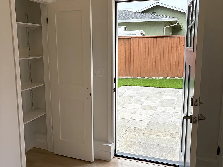 Entry door and closet with view of yard