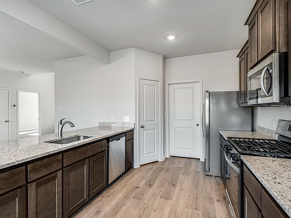 The kitchen has beautiful wood cabinetry.