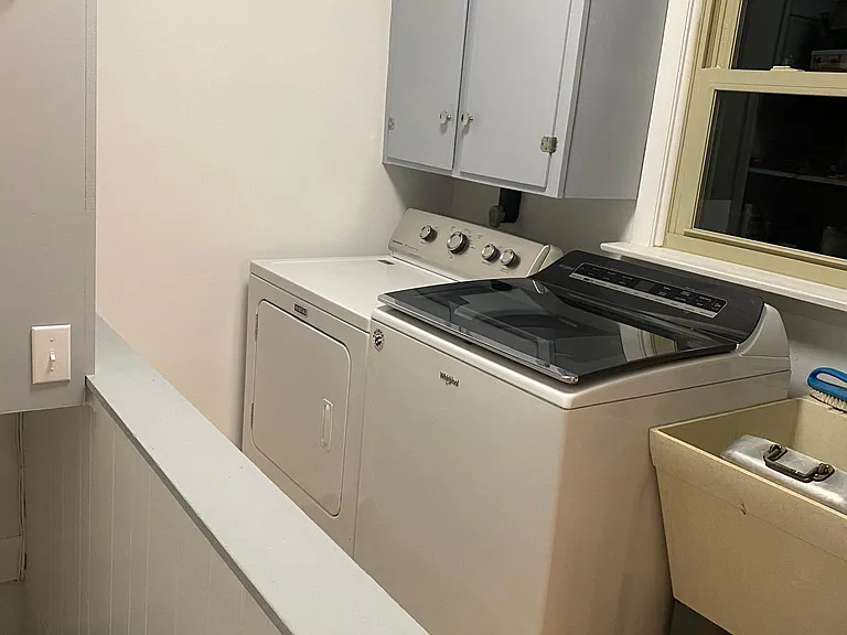 Laundry room with new washer and dryer.