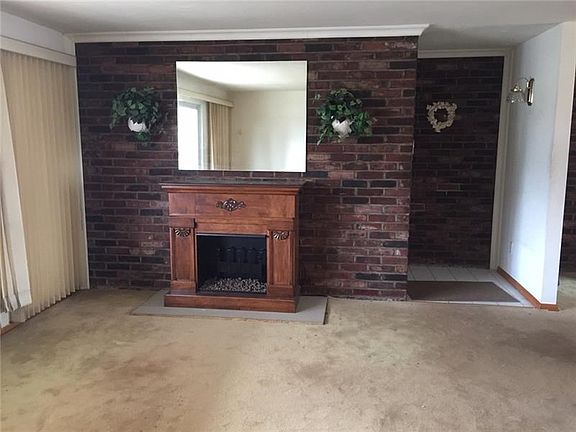 The spacious living room has several windows to allow for a lot of  natural light
