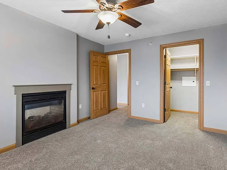 A spacious layout, cozy fireplace, and generous walk-in closet create a bedroom designed for everyday comfort.