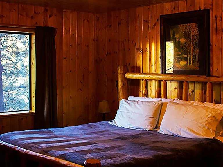 Master bedroom with a large dresser and full bathroom, views.