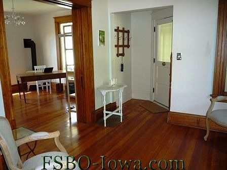 Front door & small entry; this photo is taken in the middle of the sitting room, looking into the li