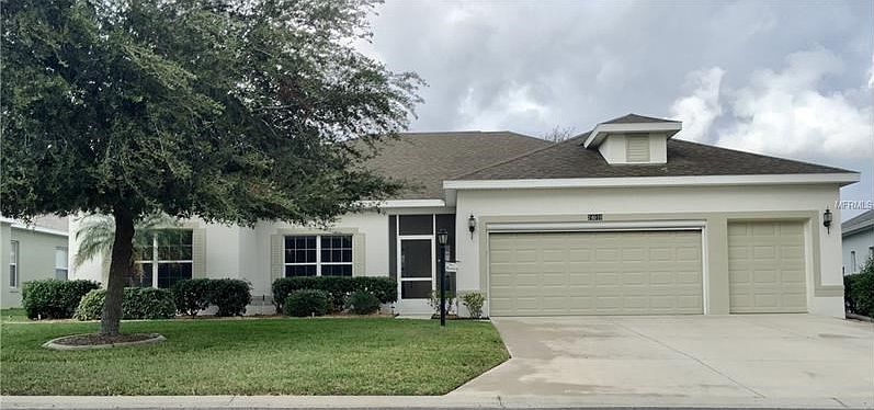 Beautifully landscaped home on a cul-de-sac.Screened in front porch.2 car garage plus golf cart garage.Double garage door includes electric roll down screen.
