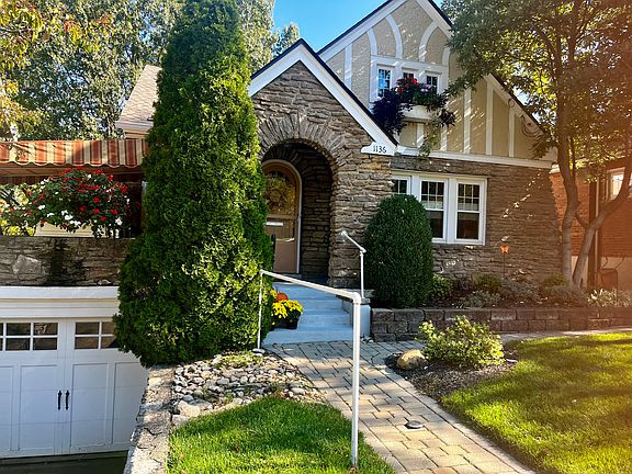 Railing up sidewalk, three steps in to home.