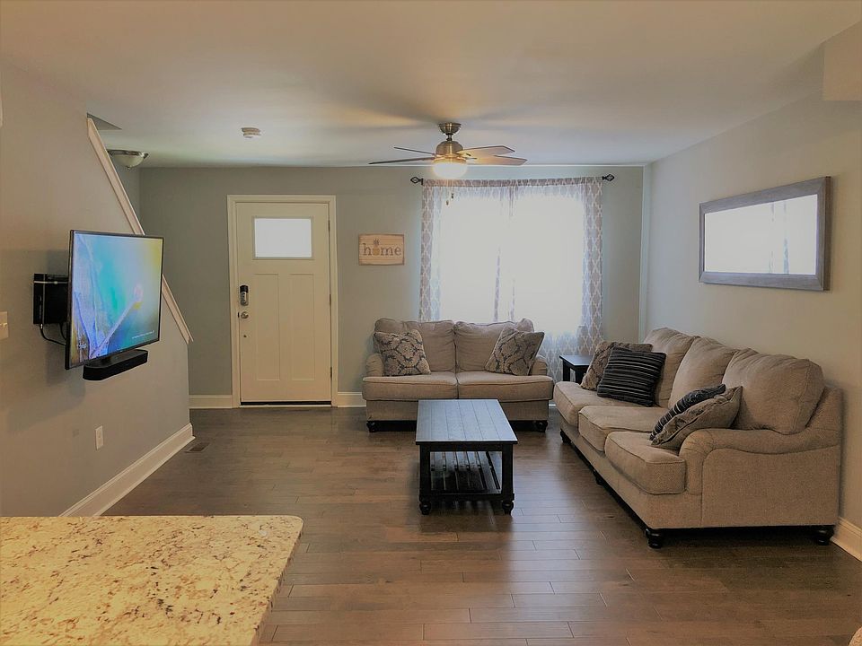 Living room and front door (taken from kitchen/dining)